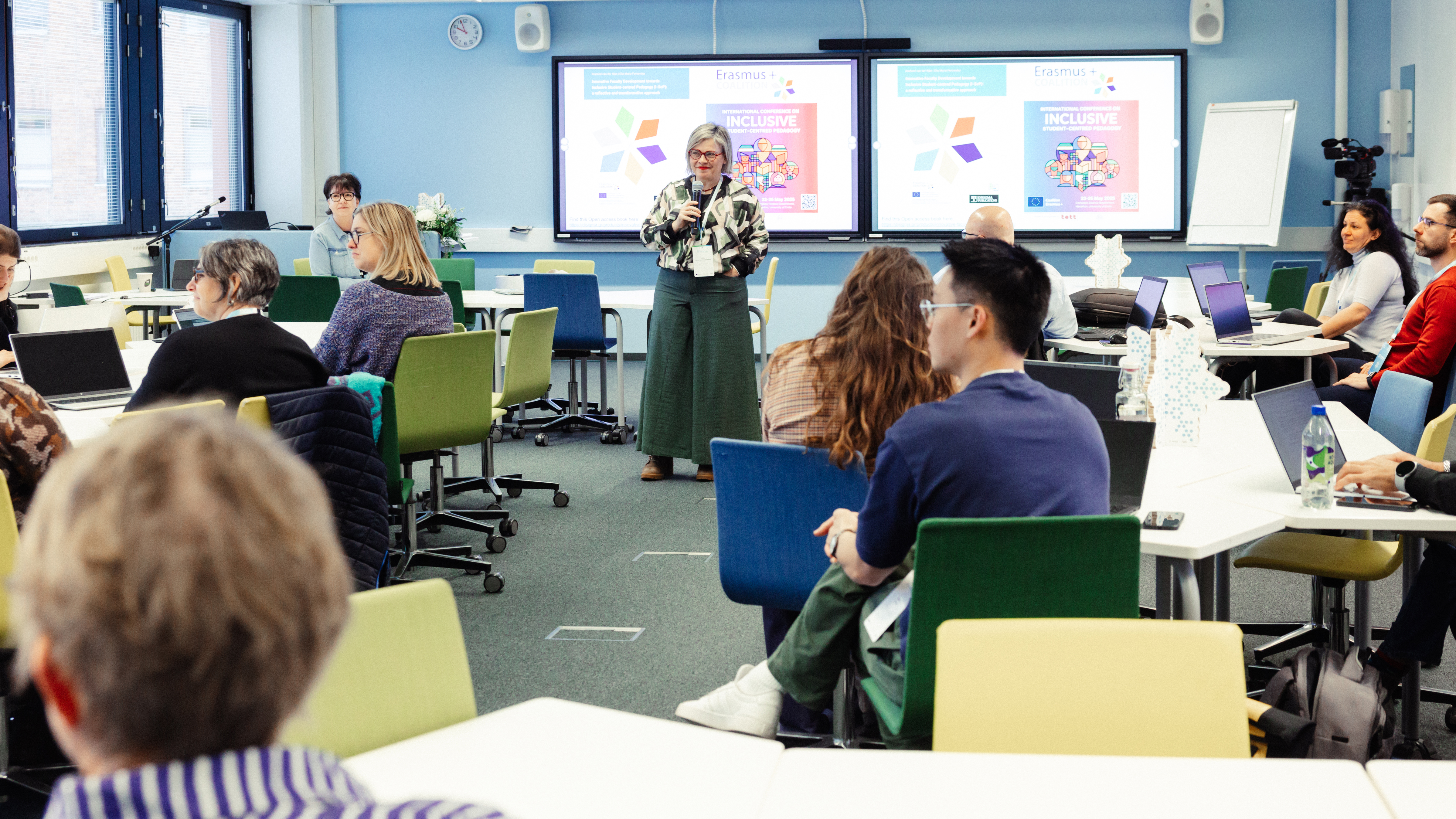 Person speaking in front of a class if people