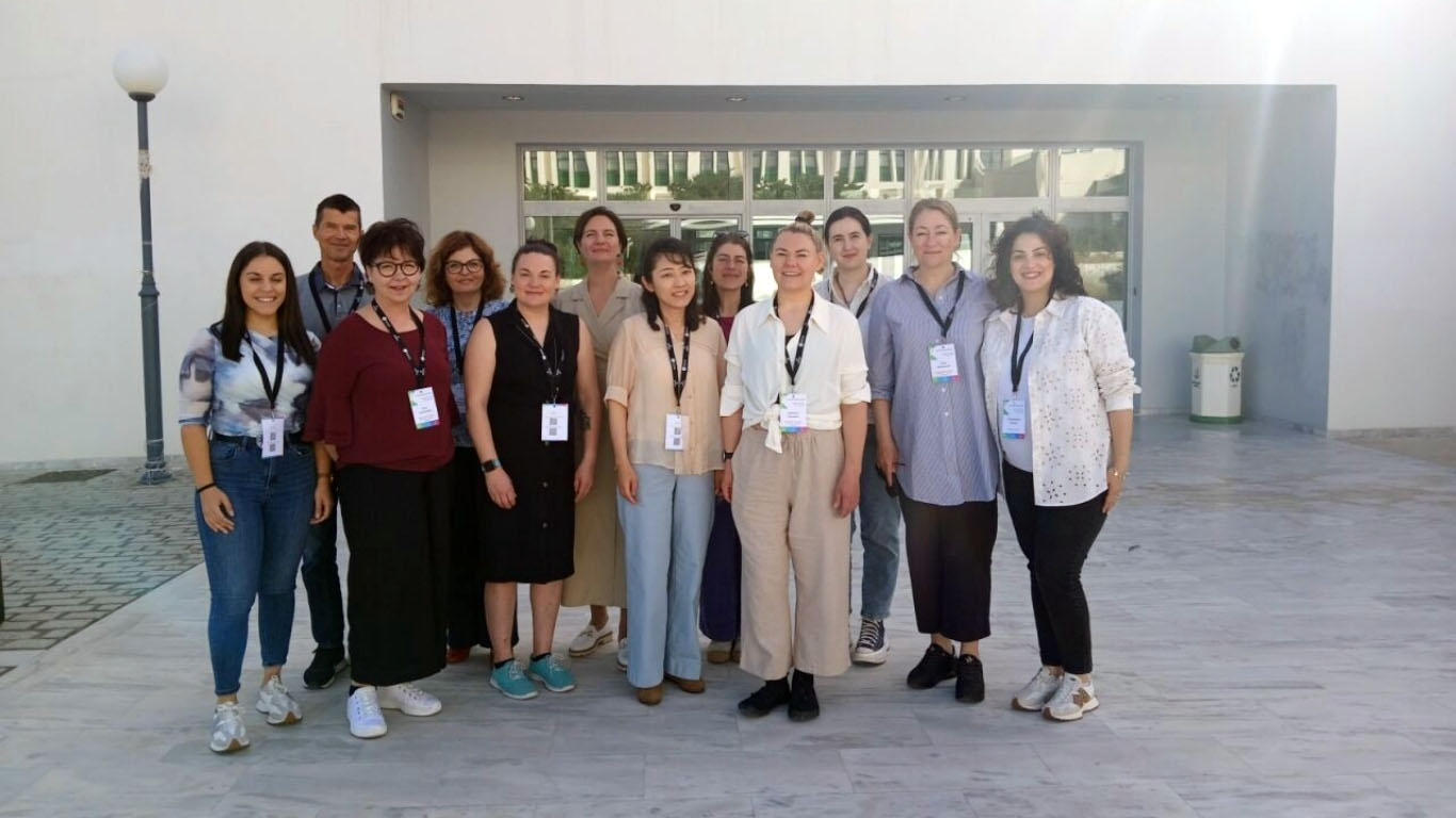 Staff Academy participants in a group picture outside the university building in Crete.